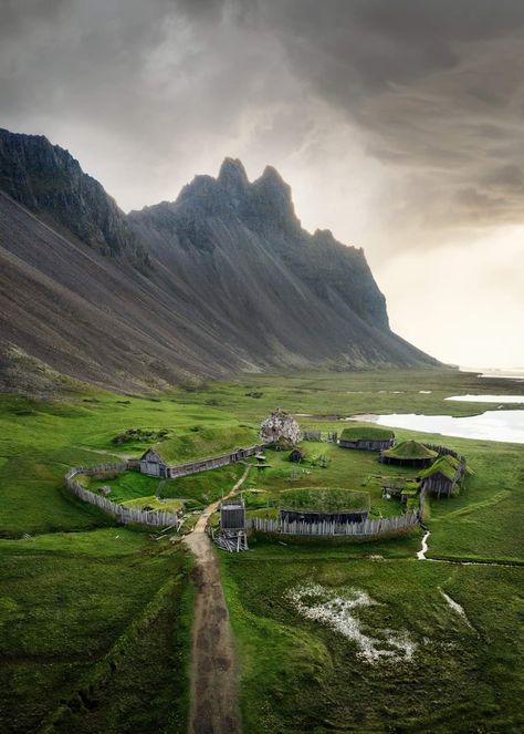 Aerial shot of small fake Viking village with mountains in background in Iceland Icelandic Vikings, Viking Ruins, Animal Backgrounds, Land Scapes, Fantasy Locations, Iceland Ring Road, Photography Hobby, Icewind Dale, Viking Village