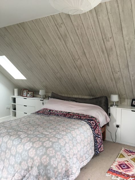 I really love my wood effect wallpaper. Perfect for a blank sloped ceiling. Loft Bedroom Ideas Sloped Ceiling Paint, Slanted Roof Bedroom Sloped Ceiling, Small Loft Bedroom Ideas Low Ceiling, Slanted Wall Wallpaper, Rooms With Angled Ceilings, Half Slanted Ceiling Bedroom, Sloped Bedroom Ideas, Triangle Ceiling Bedroom, Bedroom With Eaves