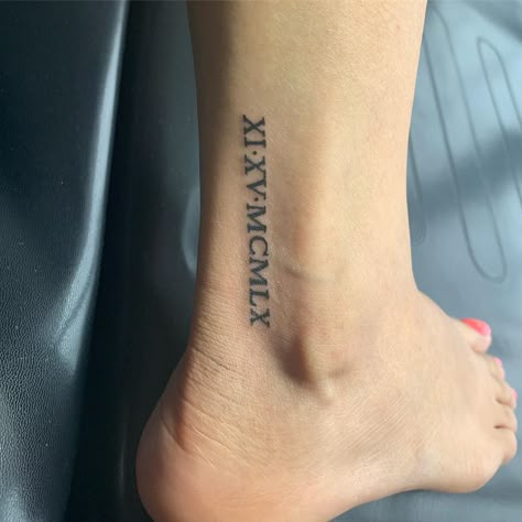 These Roman numeral tattoo ideas are all the inspiration you need to get inked. Take a look at the most sophisticated options now! Ankle Tattoo Roman Numerals, Ankle Roman Numeral Tattoo, Roman Numeral Ankle Tattoos For Women, Roman Numeral Tattoo On Ankle, Ankle Date Tattoo, 1979 Roman Numerals Tattoo, Roman Numeral Tattoo On Leg, Roman Numeral Ankle Tattoo, Roman Numeral Leg Tattoo