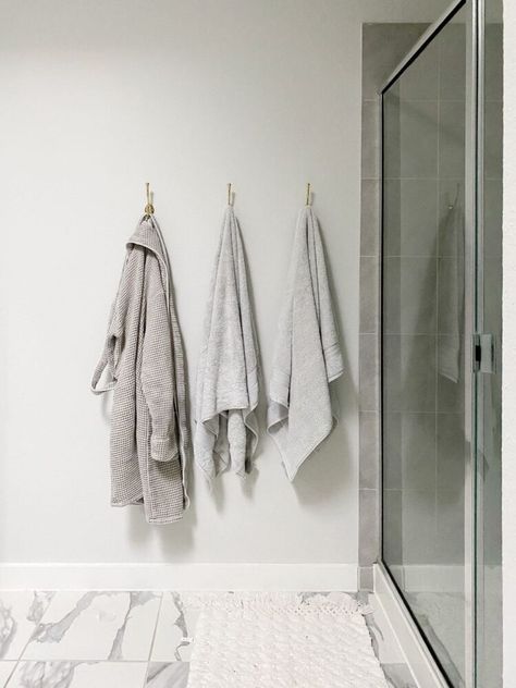 How to hang towel hooks in your bathroom to replace your towel bar - it's a quick and simple project that will make a huge difference! Towel Hook Height Bathroom, Where To Hang Robe Hooks In Bathroom, Towel Hook Height, Where To Hang Towel Hooks In Bathroom, Hooks On Bathroom Wall, Modern Bathroom Towel Hooks, How High To Hang Towel Hooks, Towel Hook Placement Bathroom, Bathroom With Towel Hooks