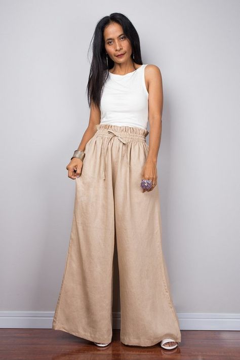 A wonderful natural beige linen wide leg palazzo pants with pockets that sits very comfortable Made with the highest care this beautifully crafted high waist womens summer pants will fit you perfect thanks to the elastic strap on the waist and the added drawstring. I like wearing this one when