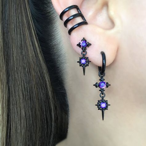 Our Classic Double North Star earrings are now available as a hoop.   Earrings are made of 316 Stainless steel, and set with Black ,Blue and  Purple  CZ. Hoops are perfect for both men and women.   Sold as Pair Total height: 40 mm Hoop Inner diameter: 10.5 mm Post Gauge: 22G (regular piercing) *RETURNS / REFUNDS * -If you would like to return you purchase , please contact us within 7 days of receiving your package and we will accept the return.Return will only be made to the product, and not the shipping cost.  -Buyer is  responsible for the return shipping costs . -All jewelry must be returned unworn and in their original condition . *LOST MAIL* Once the package is marked as DELIVERED by the post office, we are not responsible for misplaced or stolen packages. *MAIL THEFT* If parcel is st Stars Earrings, Star Hoop Earrings, Earrings Gothic, Jewelry Purple, Earrings Star, Starburst Earrings, Gothic Earrings, Magical Jewelry, Purple Earrings