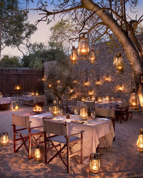 The magic and mystery of African feast in the traditional boma style setting. Ngala Safari Lodge with a romantic colonial style inspired design is in the middle of African bush charm is a luxury private game reserve built next to the famed Kruger National Park. Gala Setup, Safari Lodge Decor, Safari Lodge Interior, Rustic Restaurant Interior, Lodge Interiors, Safari House, Garden Celebration, Lodges South Africa, African Safari Lodge