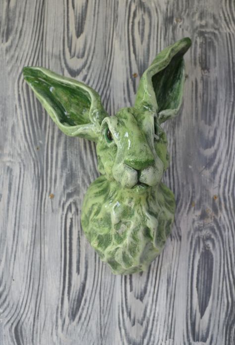 THIS LISTING IS FOR A COMMISSION GREEN HARE SIMILAR TO THE HARE IN THE PHOTO. From receipt of order to dispatch is 10 weeks This hare is hand-made and will be very similar to the one in the photo - no two are the same but will be as close to this one as possible.  Shades of green rabbit head with emerald green eyes These beautiful individual rabbit/hare sculptures are made from airdrying clay and apoxie clay. Each piece is a one-off design. Hand-painted using acrylics and then finished with a cl Animal Sculptures Clay, Clay Rabbits, Animal Head Wall Art, Clay Rabbit, Felt Animal Heads, Animal Ceramics, Emerald Green Eyes, Air Dry Polymer Clay, Crafts For Easter