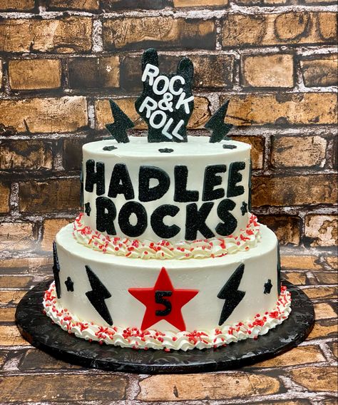 Rock & Roll birthday cake. White cake with Swiss meringue vanilla bean buttercream. Fondant hand lightning bolts, stars and name with black glitter and pixie dust. Rock And Roll 1st Birthday Cake, Another One Bites The Dust Birthday Cake, Rockstar Cake Ideas, Rock N Roll Cake Birthday, Rock And Roll First Birthday Cake, Born To Rock Cake, One Rocks Birthday Cake, Born Two Rock Birthday Cake, One Rocks First Birthday Cake