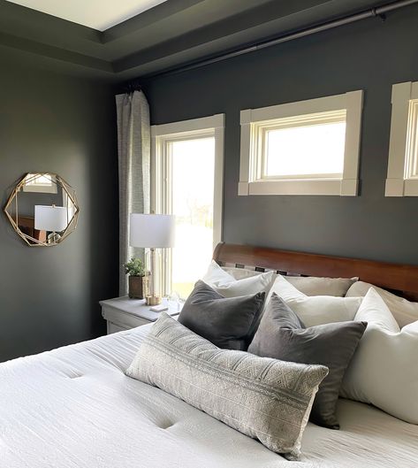 This owner’s suite is transformed with a dark gray/green paint from Sherwin Williams, Grizzle Gray. Project: Rustic Comfort Owner’s Suite Design: Homes by Simmone Master bedroom interior design, moody master bedroom, Dark green paint colors, modern casual bedroom, owners suite design, #interiordesign #bedroomdecorideas #homedesign #homeimprovement Moody Primary Bedroom, Charcoal Grey Bedrooms, Gray Paint Colors Sherwin Williams, Grizzle Gray, Dark Bedroom Walls, Grey Bedroom Colors, Grey Bedroom Paint, Dark Gray Bedroom, Dining Room Wall Color