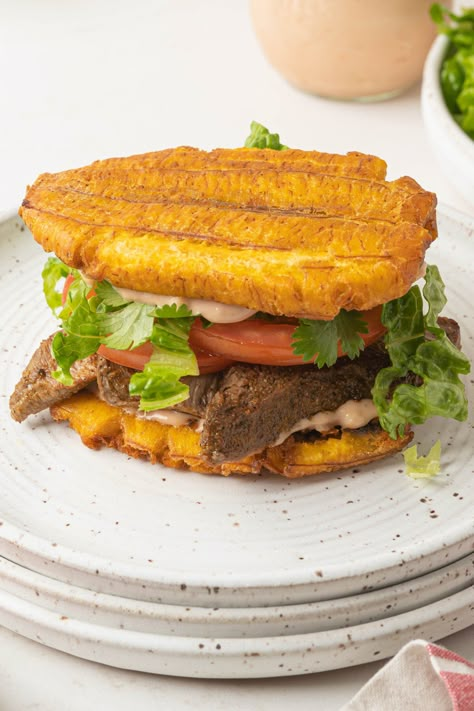 This 30 minute Jibarito is made with fried plantains instead of bread and filled with all of your favorite sandwich ingredients. It's a truly delicious piece of Puerto Rican American culture, full of unique flavor and texture. Plantain Sandwich Recipe, Tostones Sandwich, Jibarito Sandwich Puerto Rico, Puerto Rican Recipes Authentic, Jamaican Food Recipes, Plantain Sandwich, Green Plantain Recipes, Puerto Rican Mofongo, Baked Plantain Chips