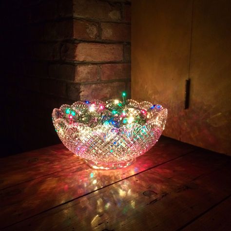 Quick party decoration! Recipe: (1) crystal punch bowl, add strand of multi-color lights, plug and enjoy.  *be mindful of lamp heat* Vintage Punch Bowl Ideas, Punch Bowl Repurpose, Upcycle Punch Bowl, Glass Bowl Decor Ideas Centerpieces Christmas Ornament, Punch Bowl Flower Arrangements, Punch Bowl Decorating Ideas, Crystal Bowl Decor Ideas, Repurposed Doors, Bulb Ideas