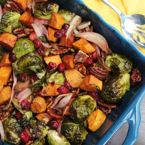 Maple Roasted Brussels Sprouts and Sweet Potatoes with Cranberries and Pecans - Brussels sprout and sweet potatoes are roasted together with cranberries, pecans, and a maple balsamic glaze, getting crispy and carmelized.  This makes for a wonderful Thanksgiving side dish or for other holidays and celebrations throughout the fall and winter! #thanksgivingsidedishes #thanksgivingrecipes #vegetariansidedishes #vegansidedishes #roastedveggies Brussel Sprouts And Sweet Potato Recipe, Brussels Sprouts And Sweet Potatoes, Sprouting Sweet Potatoes, Maple Balsamic, Thanksgiving Side Dish, Roasted Brussel, Roasted Brussels Sprouts, Sprout Recipes, Thanksgiving Side