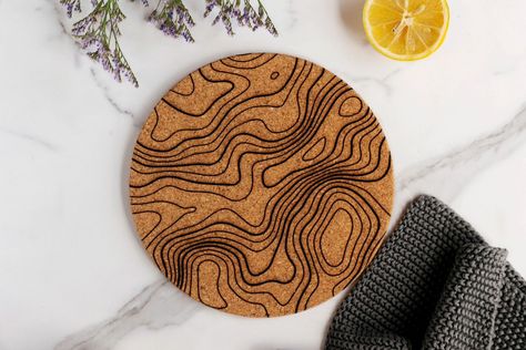 These cork trivets are great for hosting and protecting your surfaces. 😍 Grab some new designs for spring! Topography Pattern, Cork Trivet, Wedding Photo Booth Props, Cold Dishes, Hot Pad, Dog Decor, Travel Lover, Design Kitchen, Trivets