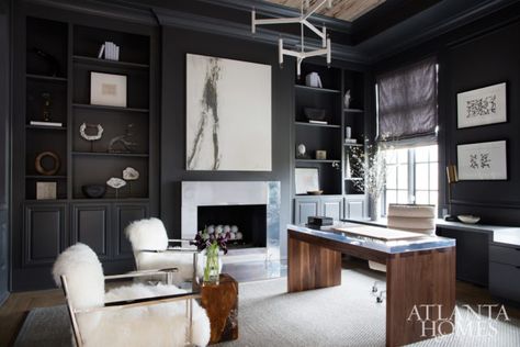 A floor-to-ceiling granite fireplace was removed to make way for a cast aluminum surround by Charles Calhoun. Soft, white accents offset masculine touches such as the acrylic-and-walnut desk. The desk and chandelier are by Grey Furniture, and the chairs are by Mitchell Gold + Bob Williams. Painting, Bonnie Fuchs. Additional artwork, Townhouse by Robert Brown. Moody Office, Salon Interior Design, Home Office Space, Study Office, Office Inspiration, Black Walls, Home Office Design, Contemporary Interior, Home Office Decor