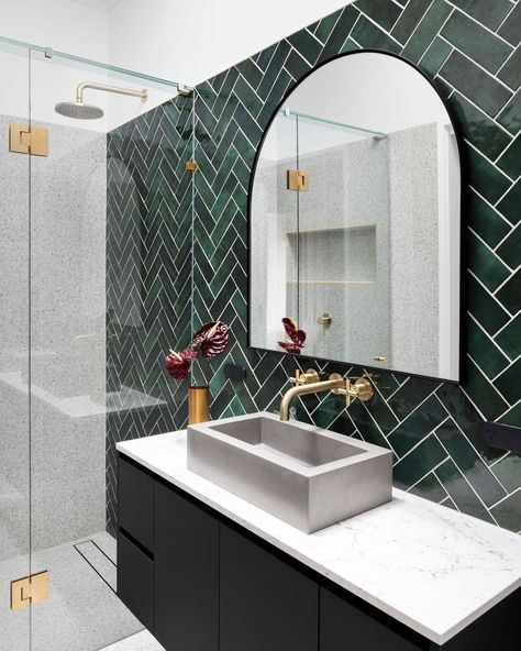 A hidden gem is unearthed ~ The symmetry of herringbone tiles in hues of emerald breath life and energy, while inclusions of concrete and… Emerald Green Bathroom, Herringbone Tile Bathroom, Green Tile Bathroom, Bathroom Design Inspiration, Herringbone Tile, Bathroom Goals, Ensuite Bathroom, Green Tile, Green Bathroom