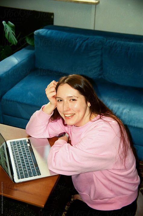 Film photo a young woman works from home, sitting on the floor surrounded by comfortable blue sofas and flowers Laptop Photography, Blue Sofas, Photography Office, Office Life, Flash Photography, Photography Work, Stock Photography Free, Blue House, Commercial Photography