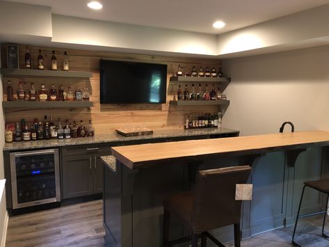 Cypress shiplap, floating shelves Basement Bar With Floating Shelves And Tv, Bar With Floating Shelves And Tv, Bar Rooms In House, Floating Shelves Man Cave, Basement Bar Shiplap, Basement Bar With Floating Shelves, Unique Basement Bar Ideas, Black Shiplap Bar, Basement Bar Ideas With Tv