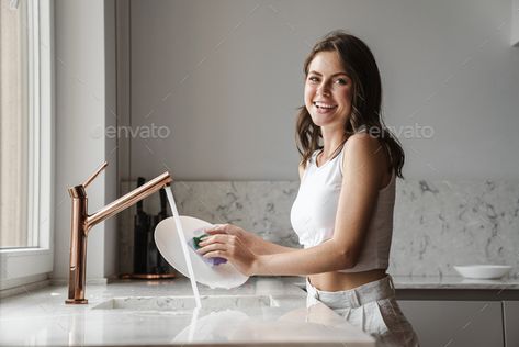 image of happy caucasian woman smiling and washing dishes by vadymvdrobot. image of happy caucasian woman smiling and washing dishes in kitchen at home #Sponsored #woman, #smiling, #caucasian, #image Woman Smiling, Washing Dishes, Illustration Artwork, In Kitchen, Pose Reference, Surrealism, At Home, Mirror Selfie, Collage