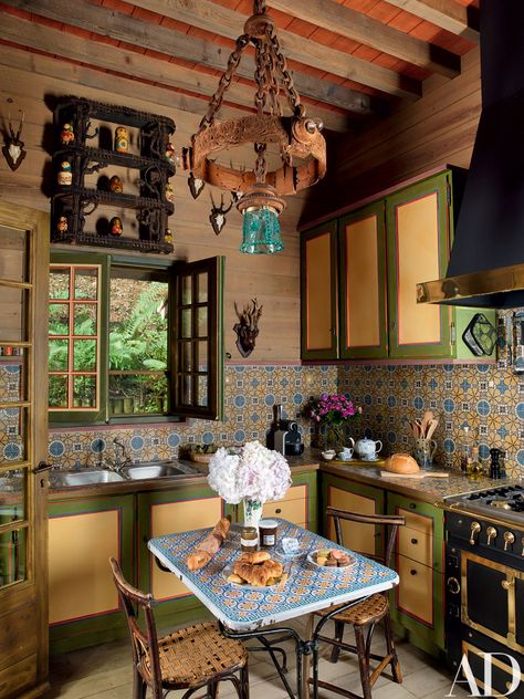 A 19th-century Eastern European light fixture hangs in the kitchen; antique French tiles pave the backsplash, and the range and hood are by La Cornue. Celebrity Kitchens, French Tile, Casa Vintage, Architectural Digest, Log Homes, Rustic Kitchen, Kitchen Backsplash, Interior Design Kitchen, House Inspiration