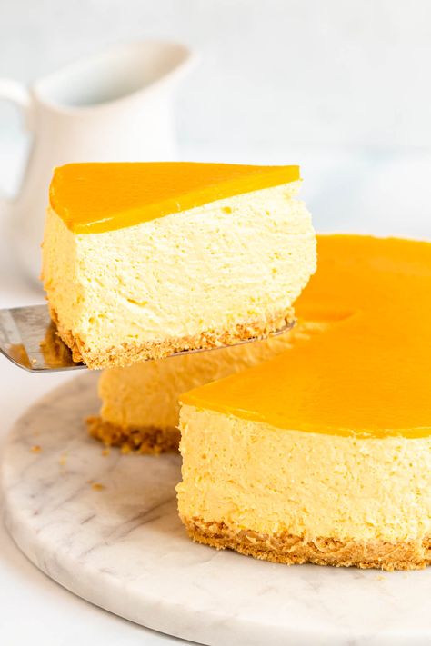 Slice pulled away from a no bake mango cheesecake.