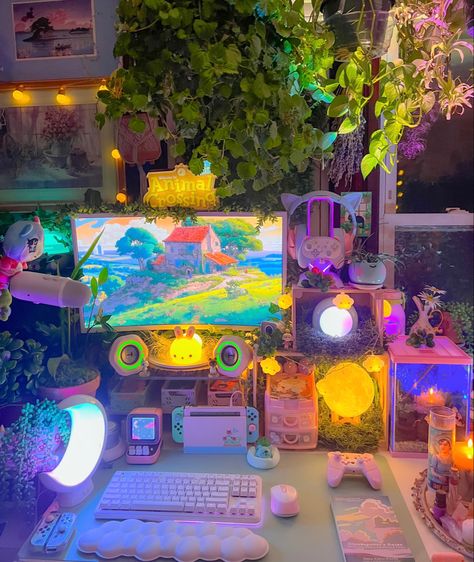 A video gaming setup featuring clouds, pastels, flowers, a lot of plants, and colorful soft lighting at night. Video gaming setup with cozy gaming in mind. Cute Cozy Gaming Setup, Dorm Gaming Setup, Cozy Game Setup, Colorful Gaming Setup, Whimsical Gaming Setup, Rainbow Gaming Setup, Kidcore Gaming Setup, Forest Gaming Setup, Cottage Core Gamer Setup