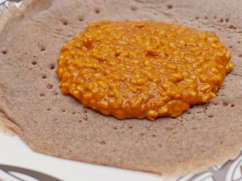 Mesir wat, or misir wat, is a spiced puree of red lentils, one of several types of bean or lentil stews that are served with Ethiopian meals. Mesir Wat, Ethiopian Dishes, Red Lentil Stew, Ethiopian Recipes, Injera Bread, Lentil Stew Recipes, Ethiopian Cuisine, African Foods, Ethiopian Food