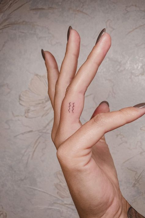 Best Aquarius Tattoos, Aquarius Tattoo Small Zodiac Signs, Mini Aquarius Tattoo, Small Zodiac Tattoos Aquarius, Aquarius Finger Tattoos For Women, Minimalist Tattoo Aquarius, Aquarius Tattoo Finger, Finger Tattoos Aquarius, Aquarius Tattoo Fine Line