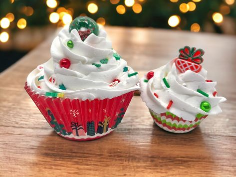 These two fake Christmas cupcakes were handcrafted with love and are perfect for adding a unique touch to tiered tray displays. This set includes one regular sized and one mini fake cupcake. The liners have different fun prints on them, and the cupcakes are topped with different fake Christmas sprinkles and charms. You will receive the two pictured. US orders over $35 ship free! Faux Cupcakes, Fake Cupcakes, Faux Christmas, Christmas Sprinkles, Tray Display, Handcrafted Decor, Fake Bake, Christmas Cupcakes, Handmade Holiday