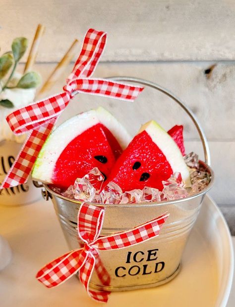 Bring a touch of summer to your home with this delightful faux watermelon slice set. Housed in a small farmhouse-style bucket with fake ice cubes, these slices are perfect for adding a pop of color to your tiered tray displays. The watermelon slices look incredibly realistic complete with bright pink-red tones and green colors with realistic looking seeds.The ice bucket and fake ice cubes add an element of fun and authenticity to the display, making it a great option for summer-themed decor. Watermelon Tray, Watermelon Centerpiece, Fake Ice Cubes, Watermelon Crafts, Fruit Crafts, Watermelon Decor, Watermelon Summer, Tiered Tray Diy, Faux Food