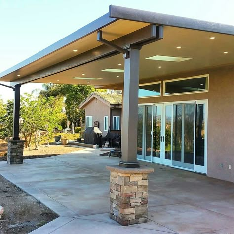 Insulated aluminum patio cover with skylights, LED recessed lighting and stone wrapped columns #aluminumpatiocover #stonecolumns #southerncalifornia #solidpatiocovers #alumawood #skylightsinpatiocovers Metal Building Patio Ideas, Steel Patio Cover, Patio With Skylight, Metal Covered Patio Ideas, Patio Columns Ideas, Covered Patio With Skylights, Patio Cover With Skylights, Partially Enclosed Patio Ideas, Aluminum Patio Covers Attached To House