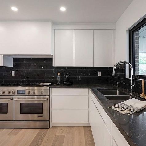 @selectsurfaceschicago on Instagram: "A good black and white design will forever have a place in our hearts. @montanalabelle creates a modern kitchen design with unique blends of black and white including Emperadoro on the counters and veined tiles on the backsplash. . . By @caesarstoneus . . . . #blackandwhite #kitchendesign #kitchenrenovation #blacktile #blackcountertop #modernkitchen #kitchendesign #kitchen #kitchendecor #kitchenorganization #kitchendesign #kitchen #kitchenremodel #marble #ma Black Kitchen Marble Counter, Black Counter Black Backsplash, Black Marble Backsplash Kitchen, Kitchen Inspo Black Counter, White Kitchen Black Tiles, Kitchen Design White And Black, White Kitchen Black Backsplash, Kitchen Black Tiles, Black Marble Countertops Kitchen