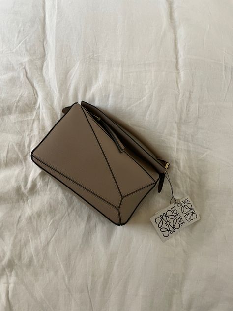 Handbag in sandy beige color on white linen bedding Loewe Puzzle Bag, Loewe Puzzle, Puzzle Bag, Personal Style, Fashion Inspo