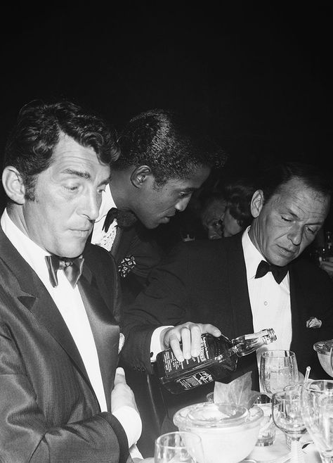 Dean Martin and Sammy Davis Jr. sit at a table as fellow singer and Rat Pack member Frank Sinatra pours Jack Daniels from a bottle at the Coconut Grove during Eddie Fisher’s opening night on July 25, 1961 ~ Los Angeles by Michael Ochs Vintage Hollywood Party, Very Important Person, Eddie Fisher, Sammy Davis Jr, Rat Pack, Jerry Lewis, American Whiskey, Hollywood Party, Perfectly Posh