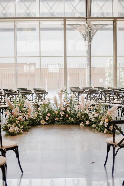 Semi circle floral floor installation for a wedding ceremony in the conservatory room at The Depot in Minneapolis. Floral by Studio Fleurette. Floral Nest Ceremony, Semi Circle Wedding Ceremony Flowers, Flower Semi Circle Wedding, Floor Floral Arrangements Wedding Ceremony, Floor Floral Arch, Ceremony Floor Arch, Floor Altar Wedding, Wedding Floral Floor Arrangements, Floor Arch Wedding Ceremony