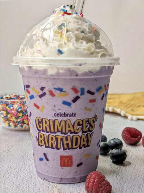 A grimace milkshake inside of a mcdonalds cup with berries and sprinkles in the background. Grimace Shake Recipe, Grimace Mcdonalds, Mcdonalds Shakes, Mcdonalds Milkshake, Birthday Cake Milkshake, Cake Milkshake, Mcdonalds Recipes, Grimace Shake, Milkshake Recipe