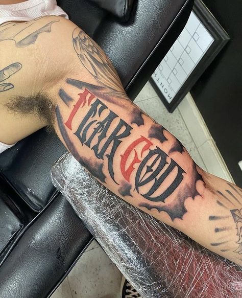 Fear God Inner Bicep Tattoo, Black God Tattoos For Men, Tattoo Ideas For Men Fear God, Red Tattoo Men Ideas, Fear None Tattoo Men Hand, Best Back Tattoos Men Design, Fear No One Tattoo Men, Fear God Bicep Tattoo, Fear God Tattoo Design