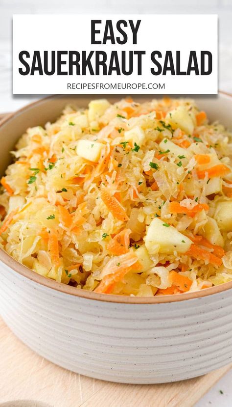 bowl of sauerkraut salad with apples, carrots and parsley and text overlay "easy sauerkraut salad". Sourkrout Salad Recipes, Sourkrout Salad, Saurkraut Recipes Side Dish, Kraut Salad Recipe, German Sourkrout Recipes, Saurkraut Salad Recipes, Sauerkraut Salad Recipes, Polish Side Dishes, Sourkrout Recipes Quick