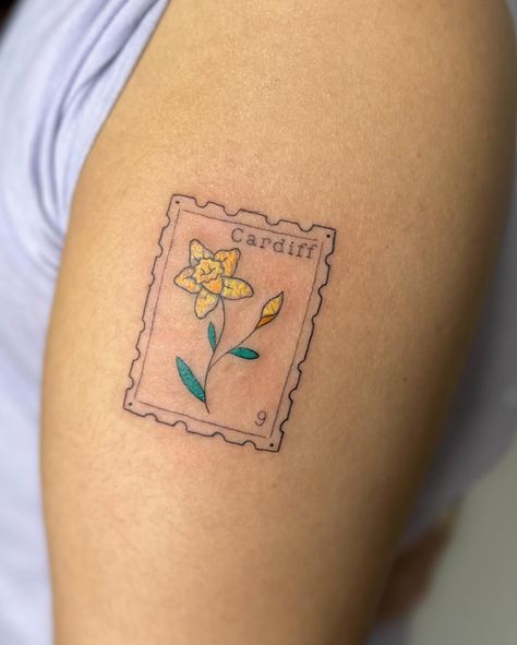 Crayon stamp tattoo to celebrate time in wales I am booking April onwards, DM TO ENQUIRE ABOUT YOUR NEXT TATTOO 💖 . . . . . . . #stamp #stamptattoo #bristol #bristoltattoo #bristoltattooartist #bristoltattoostudio #tattoo #tattoos #uktattoo #tattoouk #daffodil #fineline #finelinetattoo #finelinetattoos #colourtattoo #tattooideas #tatt #patchworktattoo . Would you get a stamp tattoo? Daffodil Postage Stamp Tattoo, Wales Tattoo, Postage Stamp Tattoo, Tattoo Uk, Stamp Tattoo, Scary Tattoos, Next Tattoo, Fine Line Tattoos, Tattoo Inspo