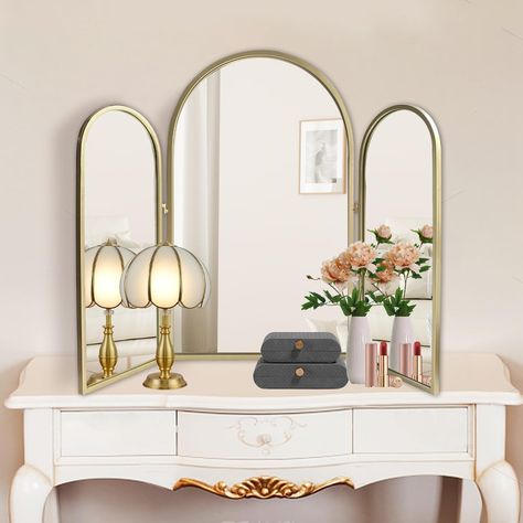 PRICES MAY VARY. ✦【Versatile & Functional】: This 2 in1 trifold mirror is designed to be versatile. It can be hung as a decorative mirror or standing on vanity as a 3-way makeup mirror. To adjust the angle of the golden frame mirrors each side for braiding hair, makeup and etc. When flat the trifold arched wall mirrors and hang it, large size mirror can brighten and complement your home decors. Besides, 3 pieces arch mirrors is large enough as bathroom mirrors or wash room mirror wall decor. ☾【St Bedroom Vanity Mirror, Bedroom Mirrors Above Dressers, Mirrored Makeup Vanity, 3 Mirror Vanity, Trifold Bathroom Mirror, Flare Aesthetic, Art Deco Vanity Mirror, Vanity Mirror Ideas Bedrooms, Glam Bathroom Decor Ideas