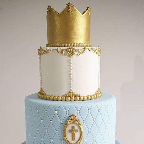 Bespoke Luxury Cake Designer on Instagram: "This cake was for the family. Isn't it lush? A christening cake for our baby Luka. This Prince themed cake was royal from top to bottom! The three layers consisted of a Victoria sponge, Cinnamon bun and cream cheese and chocolate sponge with vanilla buttercream. There was also another cake to make up feeding numbers so we decided to put a topper in it to celebrate his 1st birthday which was 2 weeks ago. Personalised biscuits favours were also a great hit. God Bless you Luka. #Crowncake #christeningcake #princecake #royalcake #kingcake #goldcake #baptismcake #carouselcake #boyscake #prettycake #harlowcakes #bishopsstortfordcake #biscuitfavours #loughtoncakes #eppingcakes #Harlow #bishopsstortford #edibleart #Buckhursthill #chigwell #Sawbridgewort Prince Theme Cake, Number One Cake, Cheese And Chocolate, Prince Cake, Royal Cakes, Personalised Biscuits, Carousel Cake, Crown Cake, Luxury Cake