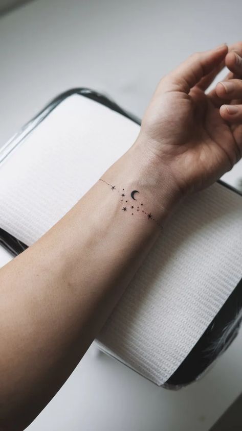 11 Bracelet Tattoo Ideas for a Delicate Look to Try - Think Creative Stars Tattoo Wrist, Stars Wrist Tattoo, Moon With Stars Tattoo, Star Wrist Tattoo, Moon Wrist Tattoo, Stars And Moon Tattoo, Bracelet Tattoo Ideas, Star Tattoo On Wrist, Wrist Bracelet Tattoo