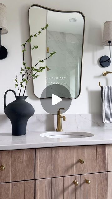 Brooke Talsma on Instagram: "Between the vertical detail on the cabinetry, the two-toned floor tile, the curved quartz backsplash and the mirror/sconce selection… there’s not an element that wasn’t thought about when designing this Secondary Bathroom 🤍
.
Design: @brookemtinteriors 
Build: @klostermanbuild" Secondary Bathroom, Brooke Wagner Design, Brooke Wagner, Mirror Sconces, Quartz Backsplash, Studio Green, Choose One, Kids' Bathroom, Floor Tile