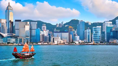 A harbor with a ship and buildings in the background in Hong Kong Victoria Harbour Hong Kong, Hong Kong Itinerary, Hong Kong Skyline, Junk Boat, Hong Kong Art, Dramatic Sky, Victoria Harbour, Ferry Boat, Cartoon Background