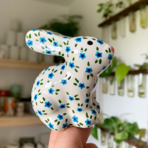 Blue ditsy florals in bunny form! Isn’t he so cute! ✨🌸🐰 Available on my website now! Link in bio ✨💕 #art #artist #ceramics #pottery #painting #illustrator #ceramicstudio #potterytiktok #potterypainting #painter #potteryart #ceramicpainter #floral #bisqueware #glaze #houseplant #creative #smallbusiness #smallbusinessowner #smallartist #floral #plate #potterylove #decor #botanical #botanicalart #potteryprocess #potteryfeature #potteryistic #artgallery #handpainted Ceramic Underglaze, Pottery Cafe, Falmouth Cornwall, Earthenware Ceramics, Pottery Animals, Ceramic Bunny, Blue Floral Design, Tiny Bunny, Hand Painted Pottery