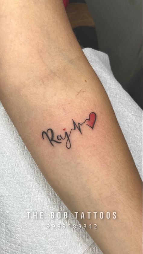 Name tattoos are done as a symbol of love and remembrance of a person's loved ones. #rajnametattoo #nametattoo #rajtattoo #rajname #tattooforman #tattooforwomen #besttattooideas #thebobtattoos #thebobtattoosnoida Raj Name Tattoo, Simple Tatto, Tattoo Design Tattoo, Symbol Of Love, Small Hand Tattoos, Name Tattoo Designs, Custom Tattoo Design, Professional Tattoo, Name Tattoo