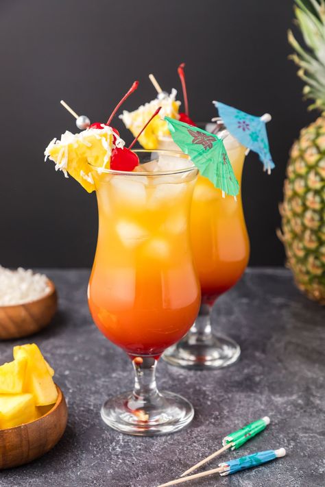 Coconut rum, pineapple juice, and grenadine are layered together in this beachy Malibu sunset cocktail. Staggering layers of fruity flavors combine to create this pretty sipper and it couldn't be easier to make. Drinks Calories, Malibu Sunset Cocktail, Bahama Mama Recipe, Bahama Mama Drink, Drinks With Grenadine, Homemade Orange Juice, Rum Cocktails Easy, Cocktails Made With Rum, Orange Juice Cocktails