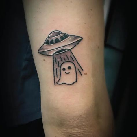 Black & Grey Small Simple Cute UFO Ghost Spaceship Tattoo Idea & Design on Women Bicep Cute UFO Ghost Spaceship Tattoo Done At Alien Abducting Cow Tattoo, Small Alien Ship Tattoo, Ufo Tattoo Simple, Cow Alien Abduction Tattoo, Spaceship Tattoo, Ufo Tattoo, Ghost Tattoo, Alien Abduction, Alien Tattoo