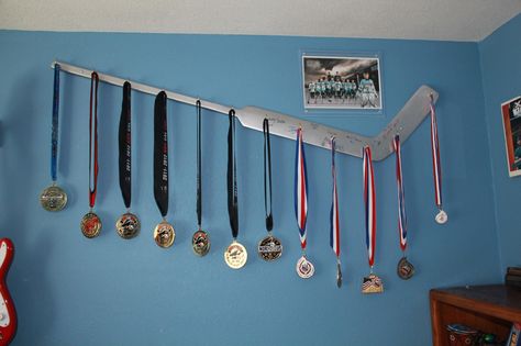 My husband made this to display my son's first season of travel hockey medals. Hockey Stick Crafts, Hockey Trophy, Sports Display, Hockey Crafts, Hockey Bedroom, Hockey Room, Hockey Decor, Trophy Display, Boys Hockey