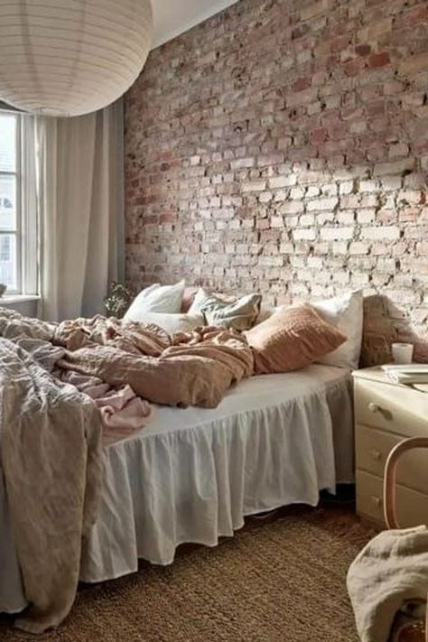 A bedroom with an exposed brick wall and a mixture of linen throw pillows in warm colors Brick Accent Wall Bedroom, Brick Wall Bedroom Ideas, Brick Bedroom Ideas, Exposed Brick Bedroom, Bedroom Brick Wall, Attic Master Suite, Brick Wall Bedroom, Brick Bedroom, Linen Throw Pillows