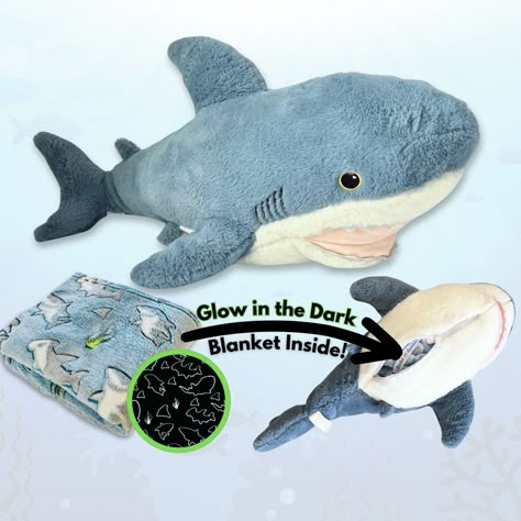 Meet Finn -- the Shark stuffed animal with a detachable glow-in-the-dark shark blanket that velcros and stores inside!  Finn the Shark is a uniquely charming plush toy featuring a delightful surprise--a 60" x 40" glow-in-the-dark shark-themed blanket tucked inside. Crafted with the softest materials, Finn promises a cozy embrace for little ones, offering a comforting companion for both playtime adventures and peaceful nights of sleep. The hand-designed blanket even detaches via velcro for easy machine wash. Expose the blanket to sunlight or bright light for 15-30 minutes to bring the glowing sharks to life! Sizing: 29" Plush with 60" x 40" Blanket Blanket Buddies is a US veteran-owned small business.  Thank you for choosing a Blanket Buddies product! Sea Creatures Plushies, Stuffed Sea Animals, Shark Build A Bear, Ocean Animal Plushies, Things To Add To Your Christmas List, Shark Gift Ideas, Shark Plushies, Shark Toys, Shark Room