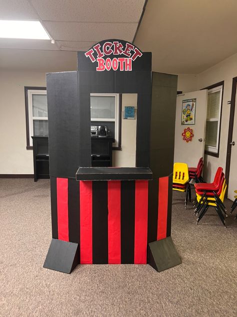 This DIY Ticket Booth is made out of 2 pieces of black trifold poster boards for the top and bottom pieces, glued together by hot glue & cardboard glue. We purposely chose black poster boards to save us time on painting. A third trifold poster board was cut into pieces to make the “Ticket Booth” sign, the small counter in the front and the legs in the front (and back, which you aren’t able to see from this angle) to help the stand from falling over. Red butcher paper used for the stripes. Movie Theater Decor Ideas, Vbs Movie Theme Crafts, Vbs Movie Theme, Movie Theater Decorations, Movie Ticket Booth Diy, Cinema Decoration Ideas, School Booth Ideas, Movie Theater Themed Party, Ticket Booth Diy