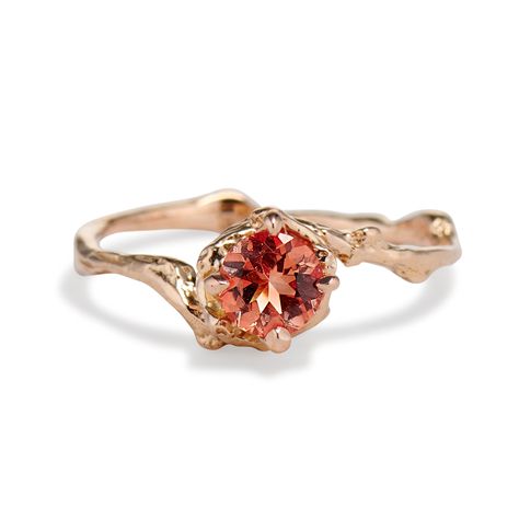 The Demi Naples Solitaire Ring features a 5mm peach pink sunstone in a nature inspired twig setting. This unique solitaire sunstone ring is crafted from a natural gemstone found in the Ponderosa Mine, Oregon. Each stone varies slightly in color and shade. Warm peach, orange, and pink hues burst forth in unmitigated beauty in our magnificent Demi Naples Oregon Sunstone Solitaire Ring. This nature-inspired ring features a stunning 5mm peachy pink sunstone set in a wrapped twig setting. The delicate twig design brings to mind the beauty of a walk in the forest, while the sunstone evokes the warmth of a summer day. The Demi Naples Oregon Sunstone Solitaire Ring melds its faceted and shining stone surface with an organic design to produce an engagement ring that is as glamorous as it is groundi Gold Ring Flower, Tulip Ring, Fingers Rings, Custom Gemstone Rings, Ruby Solitaire Ring, Feminine Nature, Contour Ring, Sunstone Ring, Red Gemstone Ring