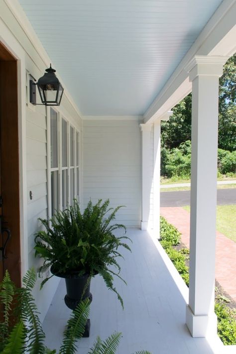 Best haint blue paint colors featuring Sea Salt by Sherwin Williams on a front door porch. This porch is from the color concierge. Sky Blue Porch Ceiling, Cottage Exterior Makeover, Coastal Cottage Exterior, Front Porch Ceiling, Haint Blue Porch Ceiling, Exterior Home Makeover, Blue Porch Ceiling, Southern Porch, Ceiling Painted